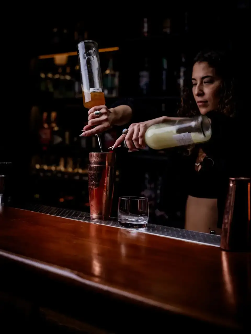A bartender mixing a cocktail