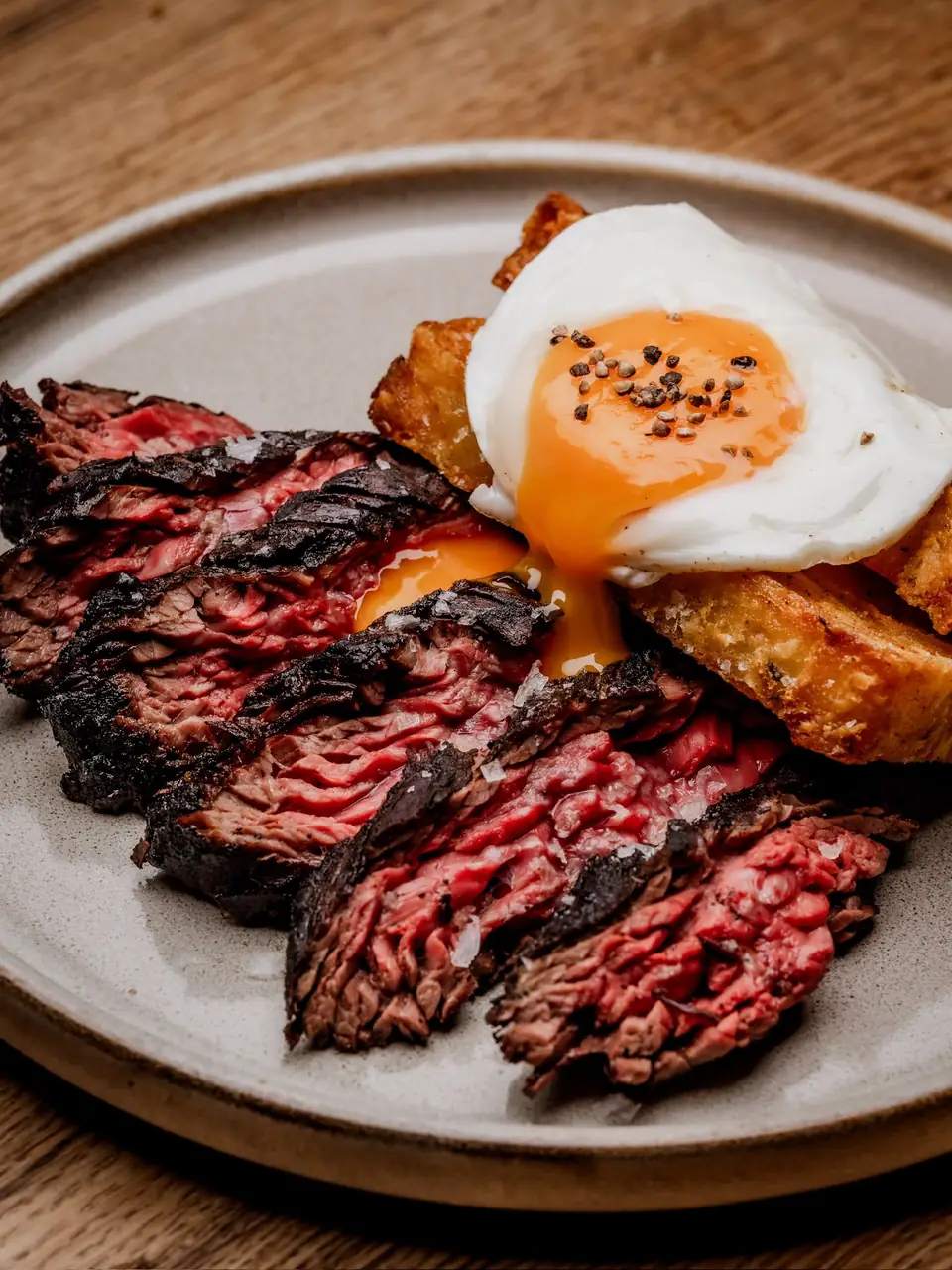 Flame-grilled steak and eggs on toast with a runny yolk