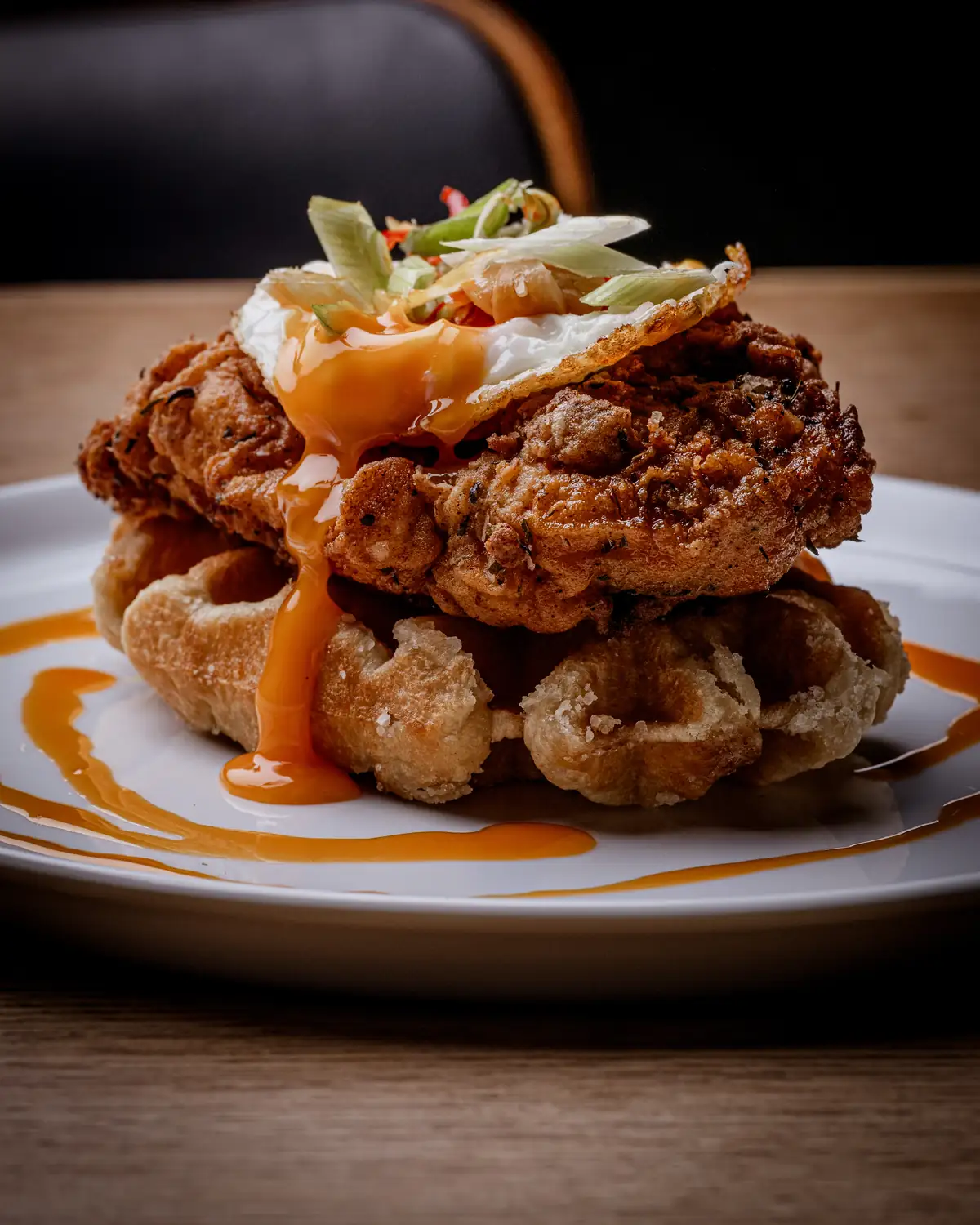 BRIX chicken & waffles with a fried egg and hot sauce