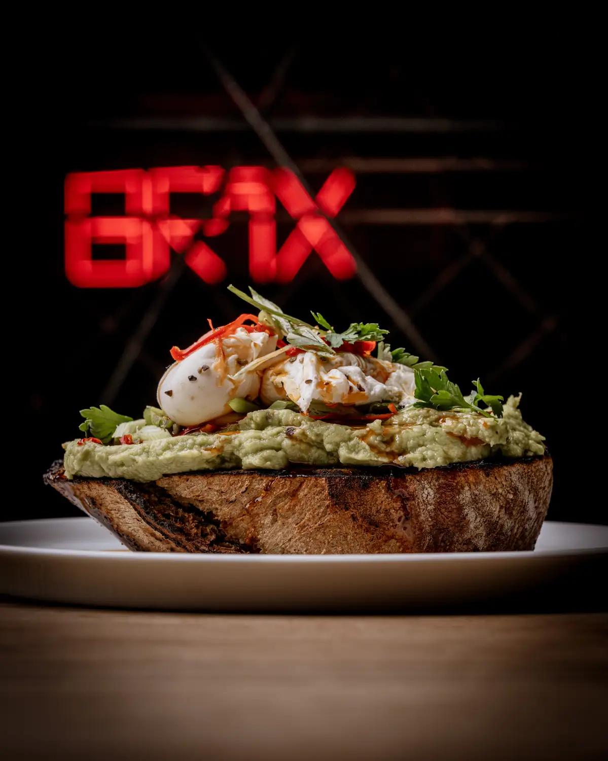 Smashed avocado on charred sourdough with poached egg