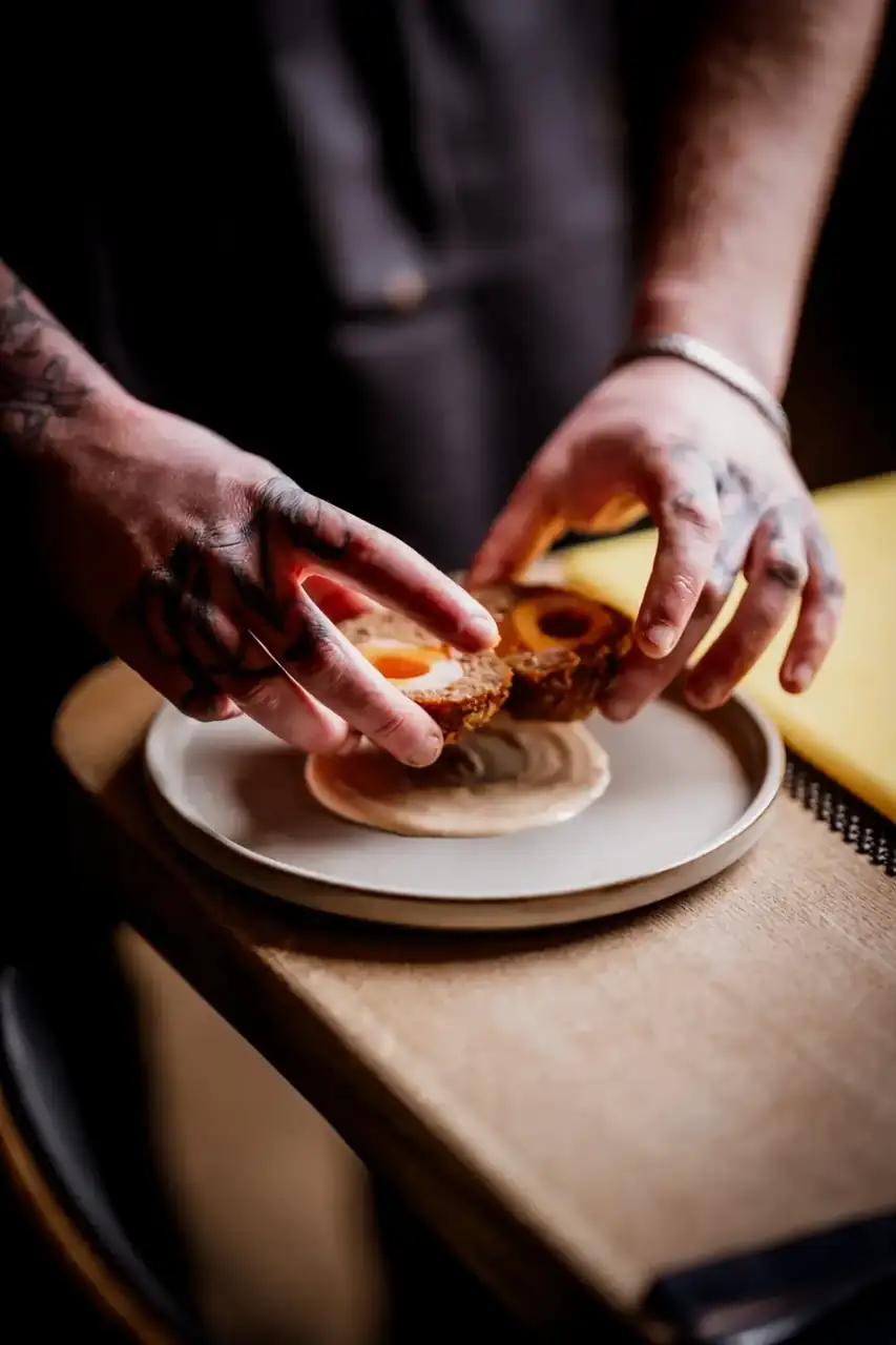 Chef plating a dish at the pass