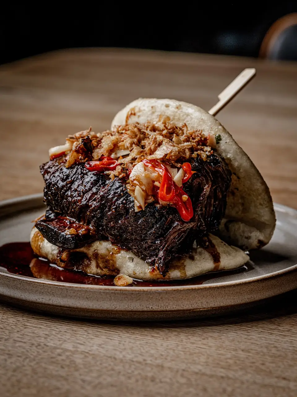 Braised short rib bao bun with crispy onions, pickled chilli and soy-honey glaze