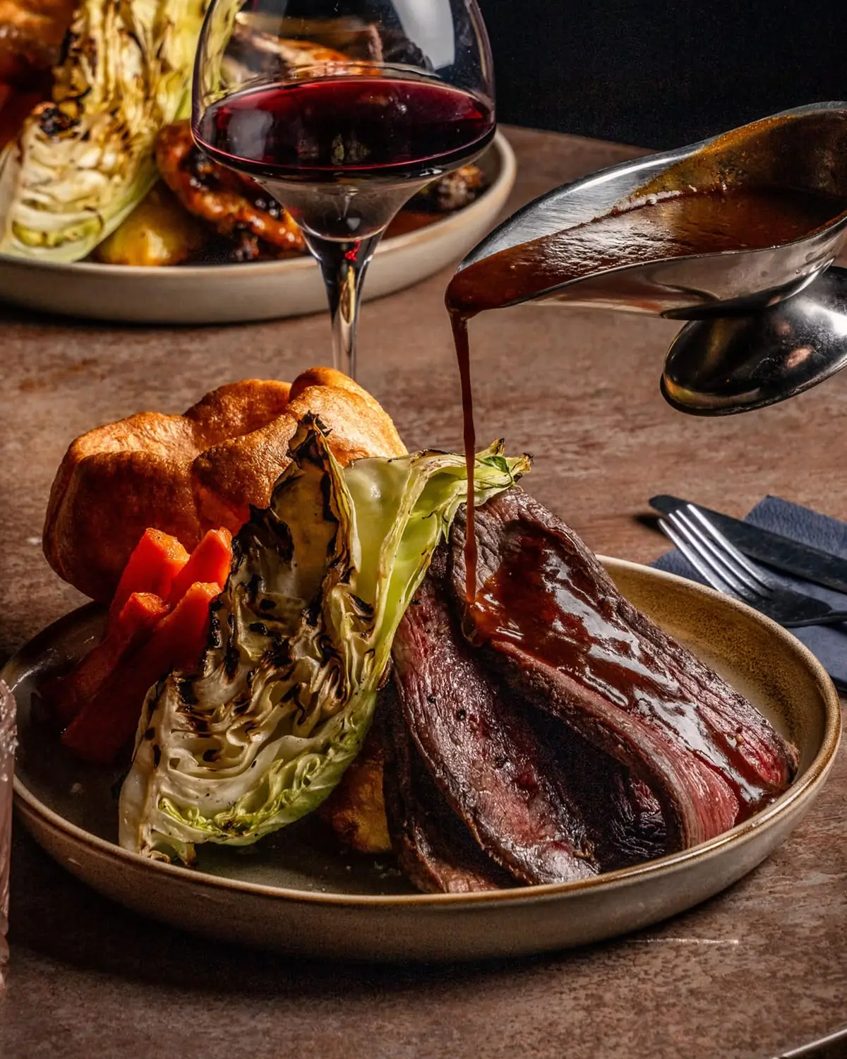 Dry-aged beef rump roast with Yorkshire pudding, charred hispi cabbage and a gravy pour