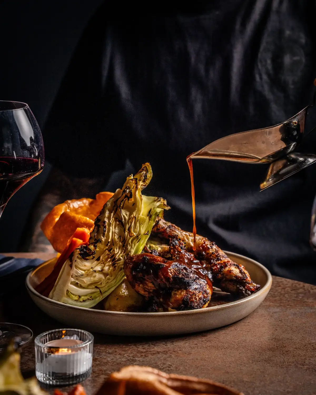 Fire-charred chicken Sunday roast with a gravy pour