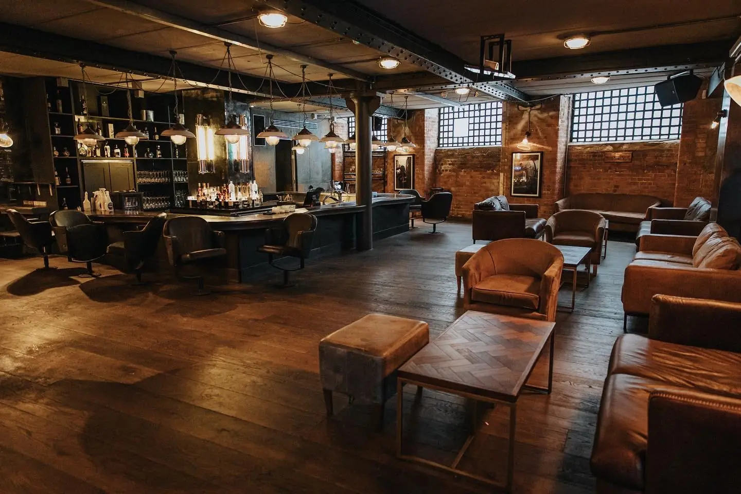 SIXT33N basement — the long bar, leather lounge seating and exposed brick