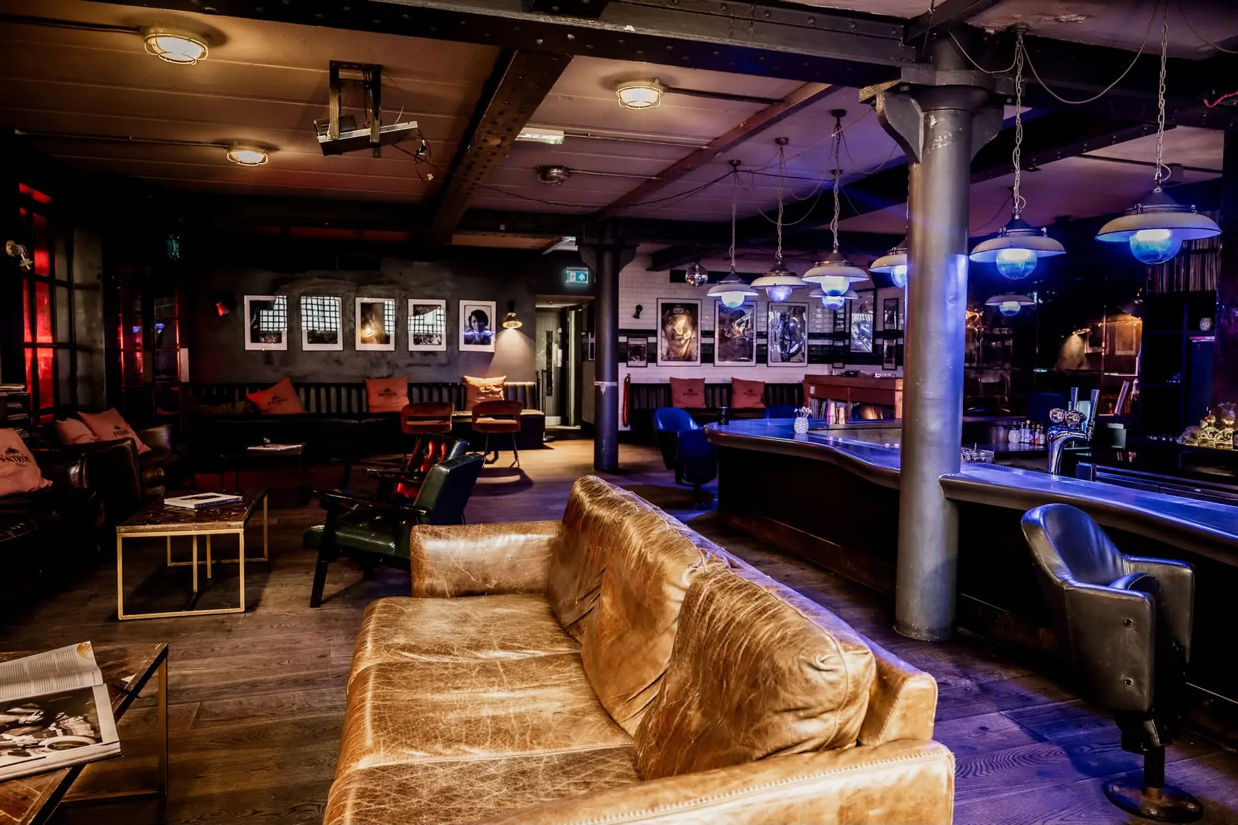Worn leather sofas, framed photography and the bar