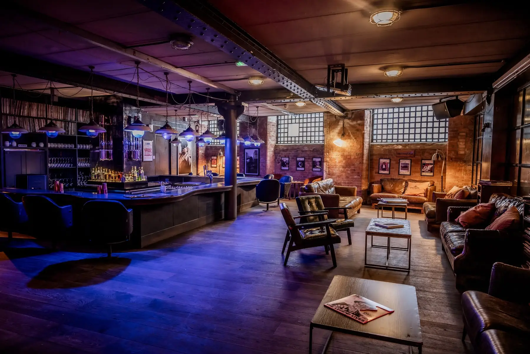 SIXT33N basement — the long bar, leather lounge seating and exposed brick